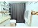 Charming bathroom with granite countertops and modern fixtures, including shower with patterned curtain at 5 Moonlight Ln, Winter Haven, FL 33884