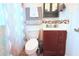Bathroom with vanity and cabinet offering ample storage, matched with a coordinating shower curtain and towel set at 5 Moonlight Ln, Winter Haven, FL 33884