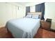 Cozy bedroom featuring a comfortable bed, nightstands, and closet space at 5 Moonlight Ln, Winter Haven, FL 33884