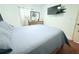 Comfortable bedroom featuring soft blue bedding, a dresser, and a mounted television at 5 Moonlight Ln, Winter Haven, FL 33884