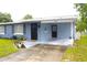 Street view of a single-Gathering home with a covered carport and a tidy front lawn and garden at 5 Moonlight Ln, Winter Haven, FL 33884