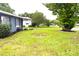 Corner lot showcasing the home with expansive yard with lush green grass at 5 Moonlight Ln, Winter Haven, FL 33884