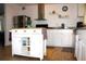 Charming kitchen featuring a movable island, stainless steel appliances, and ample counter space at 5 Moonlight Ln, Winter Haven, FL 33884