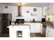 Bright kitchen featuring stainless steel appliances, an island, granite countertops, and wooden floors at 5 Moonlight Ln, Winter Haven, FL 33884