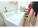 Spacious laundry area with washer, dryer, shelving, and water heater offering convenient home maintenance features at 5 Moonlight Ln, Winter Haven, FL 33884