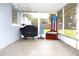 Enclosed patio featuring grill, furniture and view of the backyard at 5 Moonlight Ln, Winter Haven, FL 33884