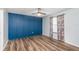 Bedroom with feature wall, hardwood floor, and ceiling fan at 89 Fremont Ave # 504, Daytona Beach, FL 32114