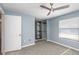 Bedroom with ceiling fan, closet, window, and door at 89 Fremont Ave # 504, Daytona Beach, FL 32114