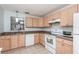 Bright kitchen with light wood cabinets, tile flooring and white appliances at 89 Fremont Ave # 504, Daytona Beach, FL 32114