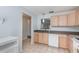Bright kitchen with light wood cabinets and tile flooring at 89 Fremont Ave # 504, Daytona Beach, FL 32114