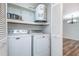 Convenient laundry area with a washer, dryer, shelving and water heater at 89 Fremont Ave # 504, Daytona Beach, FL 32114