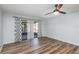 Spacious room with wood-look flooring, a modern ceiling fan, and sliding glass doors at 89 Fremont Ave # 504, Daytona Beach, FL 32114