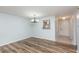 A cozy living room featuring wood-look floors, a modern light fixture, and a kitchen passthrough at 89 Fremont Ave # 504, Daytona Beach, FL 32114