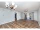 Inviting room with wood-look flooring, an elegant chandelier, and a modern ceiling fan at 89 Fremont Ave # 504, Daytona Beach, FL 32114