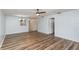 Open-concept room with wood-look floors, a ceiling fan, and easy access to other areas at 89 Fremont Ave # 504, Daytona Beach, FL 32114