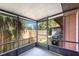 Screened porch featuring a grill and view of the backyard with a wood fence at 89 Fremont Ave # 504, Daytona Beach, FL 32114