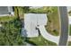 Aerial shot of home featuring a well manicured roof, lawn, and driveway at 508 Alcazar Ct, Lady Lake, FL 32159