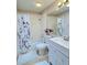 Well-lit bathroom with a tub-shower combo, white vanity, and a decorative shower curtain at 508 Alcazar Ct, Lady Lake, FL 32159