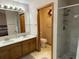 Bathroom with double sinks, a walk-in shower, and a separate toilet room for added convenience at 508 Alcazar Ct, Lady Lake, FL 32159