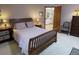Comfortable bedroom featuring a wooden bed frame, matching nightstands, and a doorway view into another room at 508 Alcazar Ct, Lady Lake, FL 32159