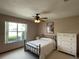 Cozy bedroom with a comfortable bed, a window for natural light, and a dresser for storage at 508 Alcazar Ct, Lady Lake, FL 32159