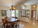 Bright dining room featuring hardwood floors, chandelier, and natural light at 508 Alcazar Ct, Lady Lake, FL 32159