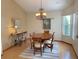 Cozy dining room with hardwood floors, chandelier lighting, and room for entertaining at 508 Alcazar Ct, Lady Lake, FL 32159