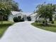Long driveway leading to a well maintained home with fresh landscaping at 508 Alcazar Ct, Lady Lake, FL 32159