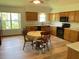 Cozy eat-in kitchen featuring wood cabinets, black appliances, and lots of light at 508 Alcazar Ct, Lady Lake, FL 32159