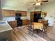 Bright kitchen with wooden cabinets, black appliances, and a cozy breakfast nook with a round table at 508 Alcazar Ct, Lady Lake, FL 32159