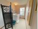 Functional laundry room with washer, dryer, storage shelf, and natural light from the window at 508 Alcazar Ct, Lady Lake, FL 32159