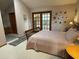 Serene main bedroom with double doors to the outside and a view into the ensuite bathroom at 508 Alcazar Ct, Lady Lake, FL 32159