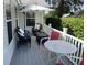 Cozy outdoor patio area featuring seating, table, and umbrella for relaxing and entertaining at 508 Alcazar Ct, Lady Lake, FL 32159