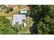Aerial view of a single-story home with a spacious backyard featuring sheds and a covered area at 13449 Ashley Ct, Grand Island, FL 32735