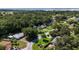 Aerial view of houses nestled in lush greenery with glimpses of swimming pools and neighborhood streets at 13449 Ashley Ct, Grand Island, FL 32735