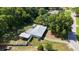 Aerial view of a house, featuring lush greenery and a well-maintained roof at 13449 Ashley Ct, Grand Island, FL 32735