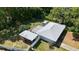 Aerial view of a home with a fenced-in backyard, lush greenery, and a shed for storage at 13449 Ashley Ct, Grand Island, FL 32735