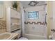 Bathroom featuring a shower/tub combination, adjacent to an organized cabinet and shelf unit at 13449 Ashley Ct, Grand Island, FL 32735