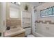 Cozy bathroom with tiled shower/tub combination, matching sink and vanity with decorative wall tiling at 13449 Ashley Ct, Grand Island, FL 32735