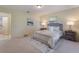 Bedroom featuring a plush bed, soft carpet, and side tables, providing a comfortable and relaxing space at 13449 Ashley Ct, Grand Island, FL 32735