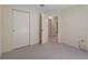 Bedroom with neutral carpet, closet, and open door that allows light and access to the rest of the home at 13449 Ashley Ct, Grand Island, FL 32735