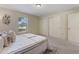 This cozy bedroom offers ample closet space and a bright window, providing lots of storage and light at 13449 Ashley Ct, Grand Island, FL 32735