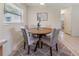 Cozy dining area with round table, comfortable upholstered chairs, and natural light at 13449 Ashley Ct, Grand Island, FL 32735