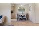 Dining area with comfortable upholstered seating, well-lit, and kitchen in background at 13449 Ashley Ct, Grand Island, FL 32735