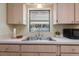 A well-lit kitchen showcases stainless steel sink and cabinetry, providing great storage at 13449 Ashley Ct, Grand Island, FL 32735