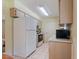 Well-lit kitchen with white appliances and neutral cabinets for a clean, functional space at 13449 Ashley Ct, Grand Island, FL 32735