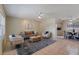 Bright open-plan living room with modern furnishings, neutral color palette, and tile floors at 13449 Ashley Ct, Grand Island, FL 32735
