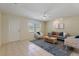 Inviting living room with tiled floors, comfortable seating, and a large bright window at 13449 Ashley Ct, Grand Island, FL 32735