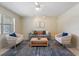 Well-lit living room with a comfortable sofa, stylish armchairs, and a cozy atmosphere at 13449 Ashley Ct, Grand Island, FL 32735