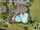 Stunning aerial view of the community clubhouse featuring a resort-style pool, sun deck, and tropical landscaping at 16324 Brisk Breeze Aly, Winter Garden, FL 34787